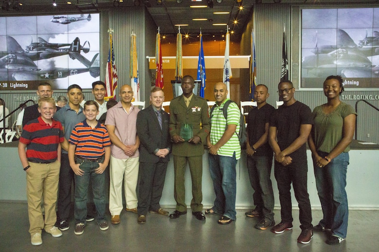 Sgt. Juvante Butler (center), an administrative specialist with 4th Marine Division, Marine Forces Reserve, and members of the Knights of Pythagoras pose for a photo at the World War II Museum in New Orleans, May 20, 2017. The Knights of Pythagoras is a mentorship program created to help council young men in the New Orleans community. (U.S. Marine Corps photo by Pfc. Melany Vasquez / Released)