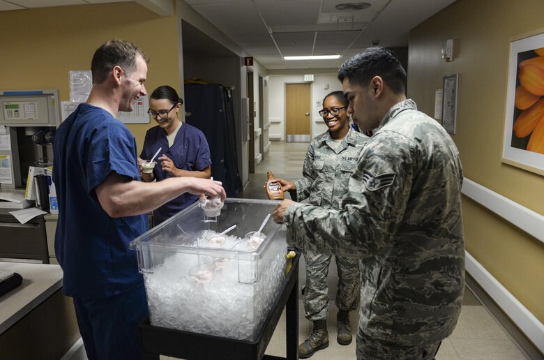 Nurses and medical technicians from the 99th Medical Group Intensive Care Unit brought ice cream as a part of Nurse and Medical Technician Week at Nellis Air Force Base, Nev., May 11, 2017. Nursing and medical technicians are physically demanding positions and often require working long hours, nights and weekends. (U.S. Air Force photo by Airman 1st Class Nathan Byrnes/Released)