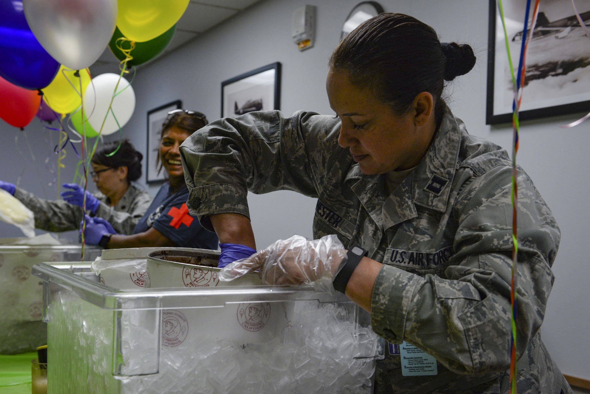 Capt. Marisa Hester, 99th Medical Group Intensive Care Unit student mentoring and retention team nurse cadre, scoops ice cream during the ice cream social in the Mike O’Callaghan Medical Center at Nellis Air Force Base, Nev., May 11, 2017. The ice cream social was just one of several events that took place for Nurse Technician Week. (U.S. Air Force photo by Airman 1st Class Nathan Byrnes/Released)
