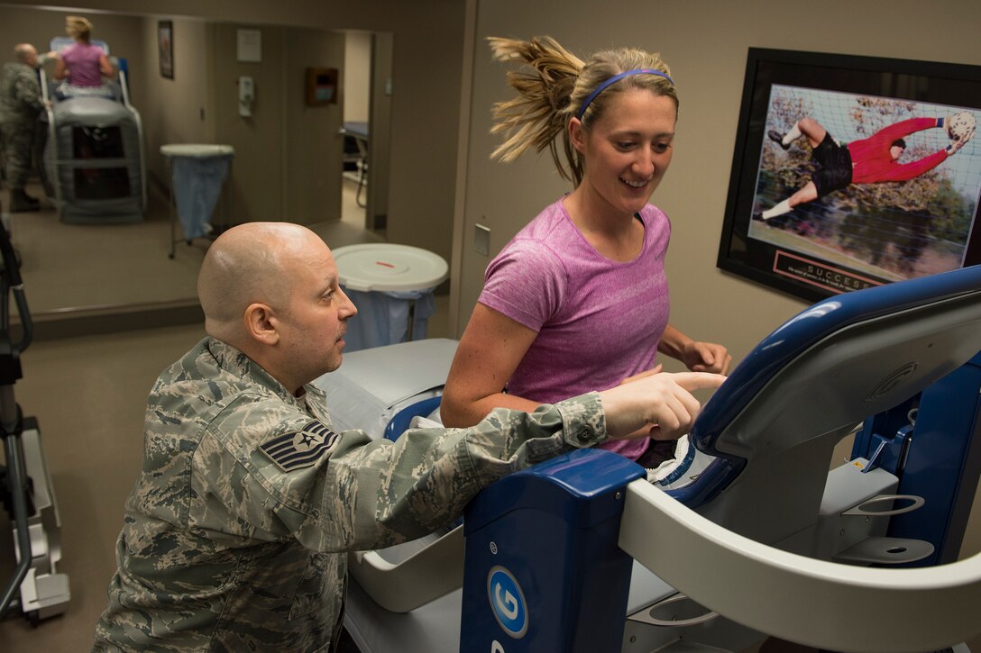 Tech. Sgt. Jesse Myers, 92nd Medical Group Physical Therapy and Orthodontics flight chief, shows Lauren Buyer, 92nd MDG physical therapist, how to operate and use all the features of the "Alter G" treadmill April 20, 2017 at Fairchild Air Force Base, Washington. The Alter G treadmill uses a pressurized chamber on the lower body to create buoyancy, lessening the impact of the user's steps and allowing running to be less painful.
(U.S. Air Force Photo / Airman 1st Class Ryan Lackey)