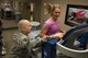 Tech. Sgt. Jesse Myers, 92nd Medical Group Physical Therapy and Orthodontics flight chief, shows Lauren Buyer, 92nd MDG physical therapist, how to operate and use all the features of the 