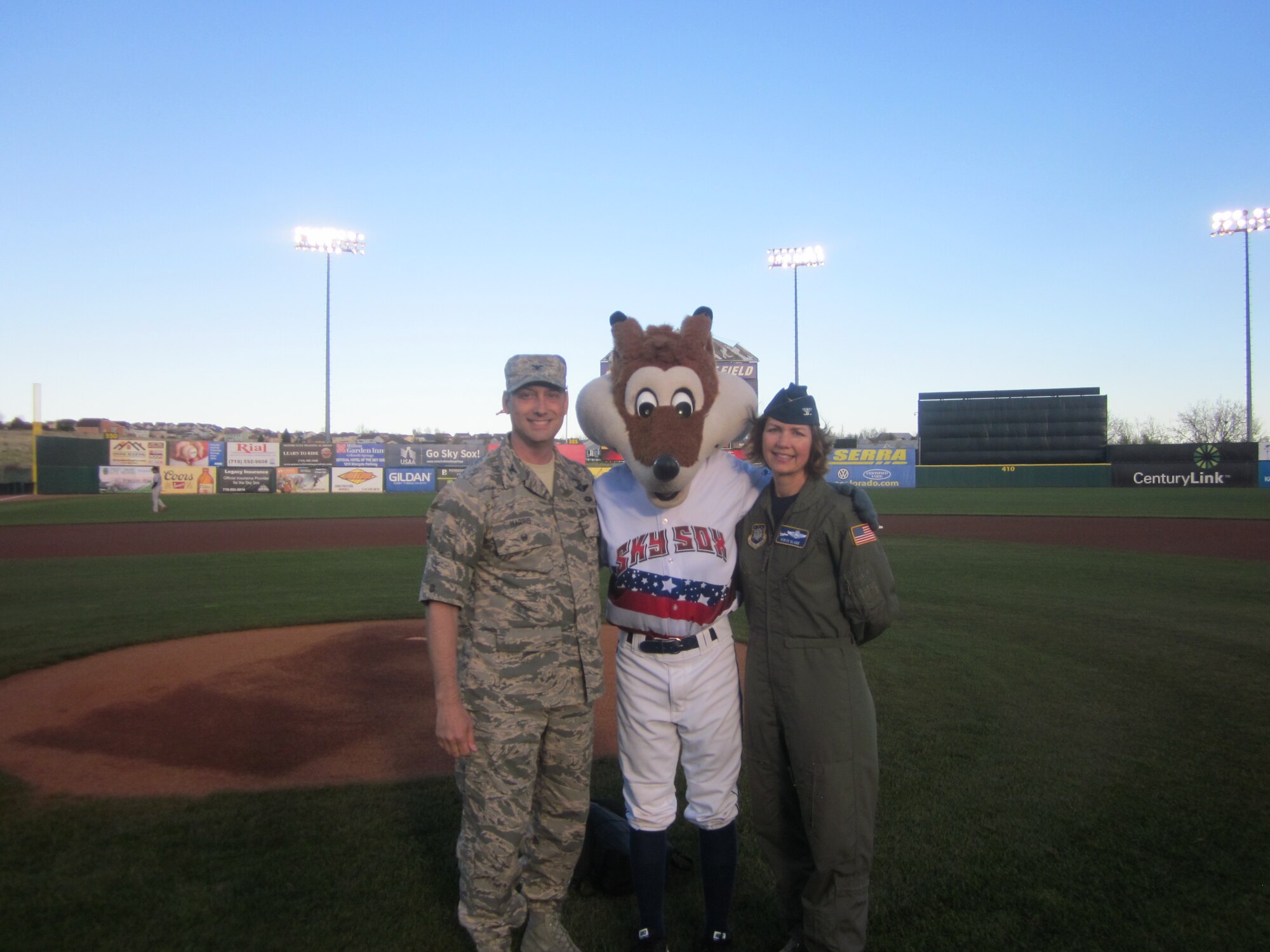 Col. Robyn Slade (right), 50th Space Wing senior individual mobilization augmentee to the commander, stands with Col. David Harris, United States Air Force Academy vice superintendent, and Sky Sox Mascot during the Sky Sox Air Force Night at Security Service Field, Colorado Springs, Colorado, Friday, May 12, 2017. The Sky Sox Air Force Night was one of the last events Slade would attend as IMA to the commander. (Courtesy photo) 