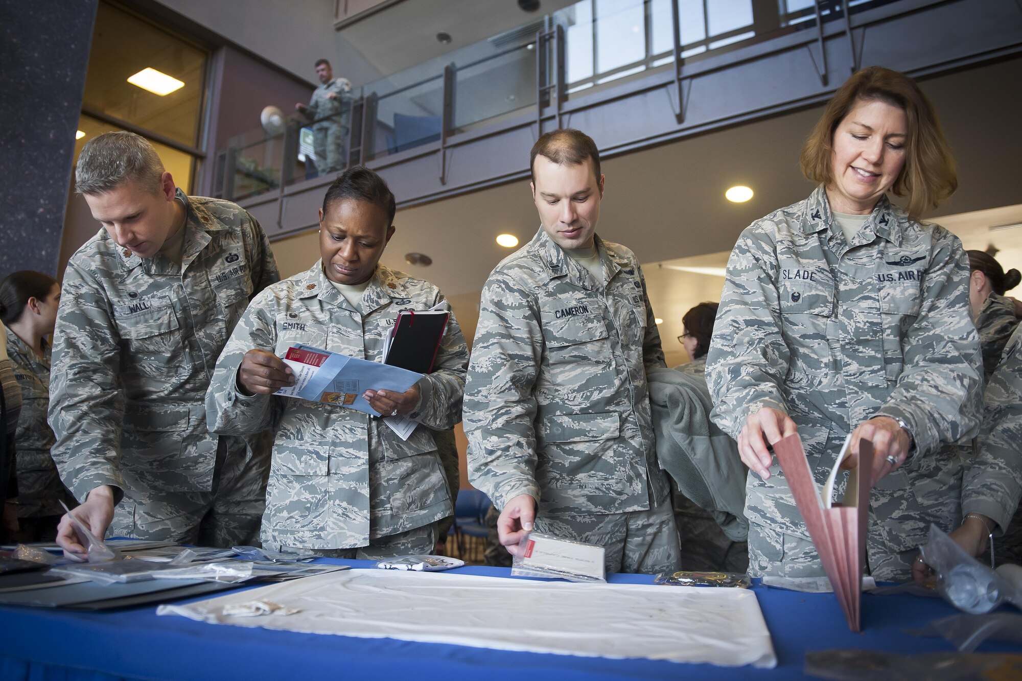 Col. Robyn Slade (right), 50th Space Wing senior individual mobilization augmentee to the commander, browses the contents of the 50 SW time capsule, opened at Schriever Air Force Base, Colorado, January 31, 2017. Being IMA to the commander of the wing during this moment in history is one of the many ways Slade has served the 50 SW during her last years of service. (U.S. Air Force Photo/Dennis Rogers)