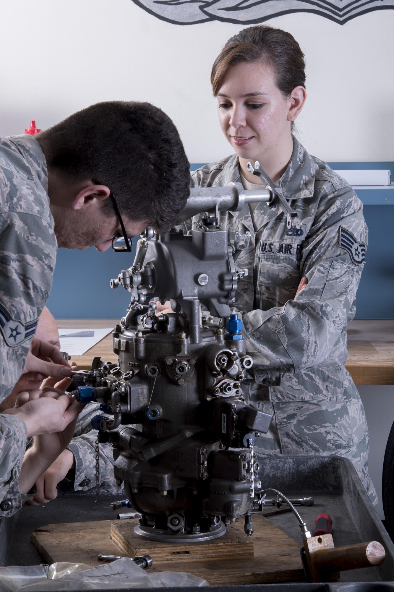 Staff Sgt. Angelica Ponce, 373rd Training Squadron Detachment 15 aerospace propulsion instructor, gives tips to students practicing skills on a C-130H Hercules training component, May 16, 2017, at Yokota Air Bare, Japan. The objective of the class is to develop C-130H Hercules maintainers’ problem solving abilities through a mix of classroom and hands-on learning techniques. (U.S. Air Force photo by Airman 1st Class Donald Hudson)