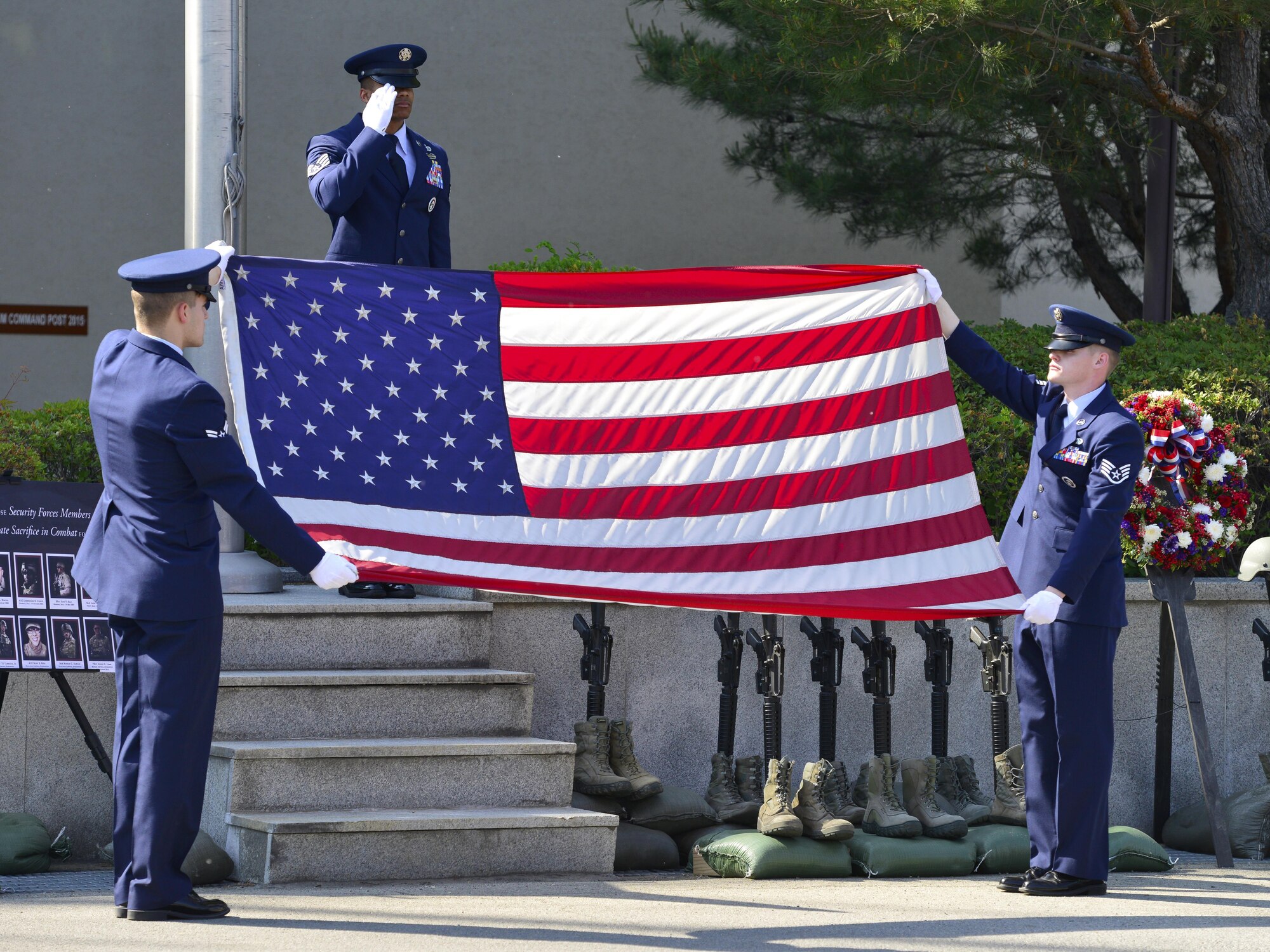 Osan Base Honor Guard members perform a flag folding presentation during a Memorial Retreat Ceremony at Osan Air Base, Republic of Korea, May 19, 2017. During the ceremony, members of the 51st Security Forces Squadron, Air Force Office of Special Investigations, Republic of Korea Air Force Military Police, and the Korean National Police honored their fallen members. (U.S. Air Force photo by Staff Sgt. Alex Fox Echols III)