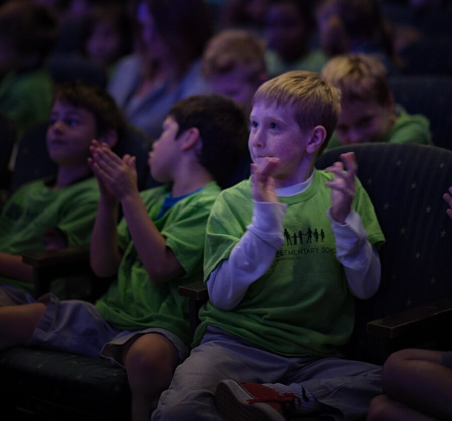 The children are delightedly applausing at the performance this past Friday of Oliver Messiaen's From the Canyons to the Stars children's concert.  (U.S. Air Force photos/CMSgt. Bob Kamholz/released)