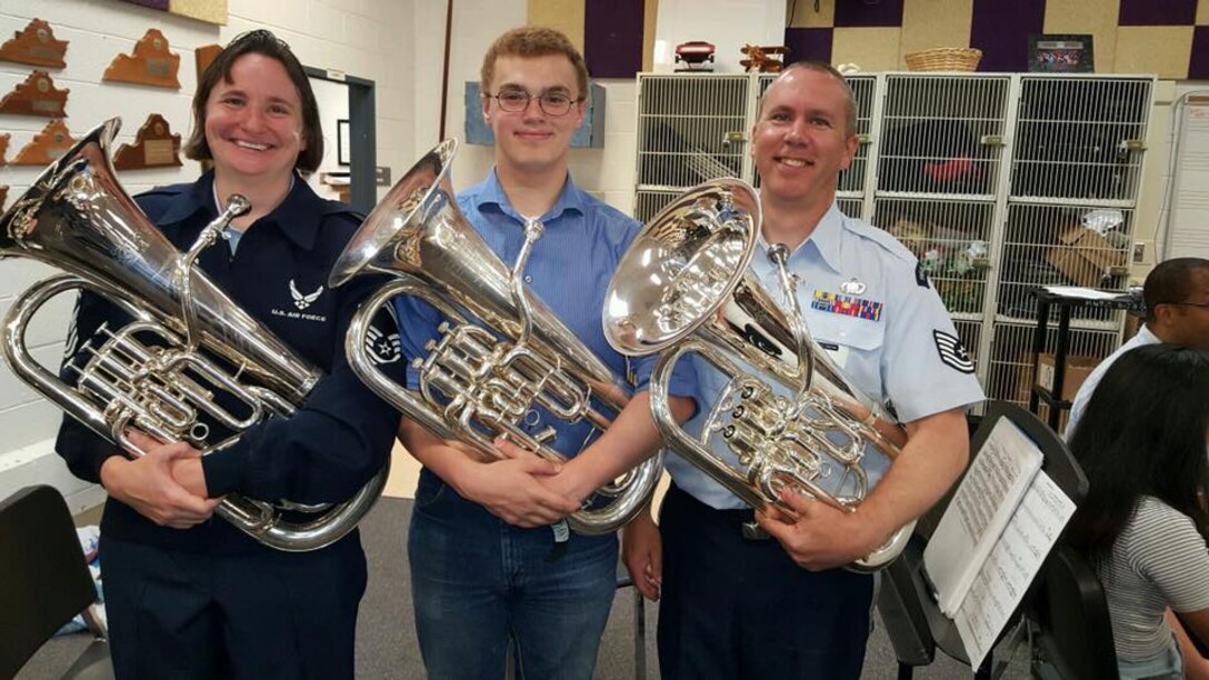 SMSgt Jen Cox and TSgt John Cox pose with a student at Lake Braddock Secondary School after a morning of side-by-side clinics with members of the Concert Band. TSgt Cox is also an alumni of the fine music program at this Northern Virginia school. (U.S. Air Force photos/SMSgt Jen Cox/released)