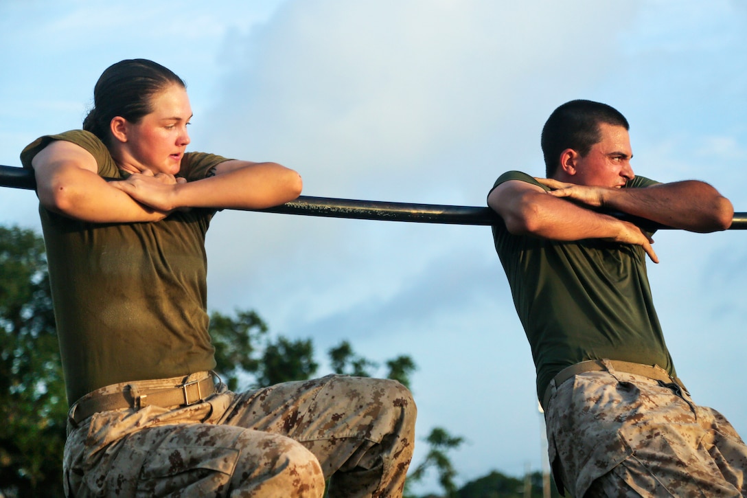 Marine Corps recruits hang on the high bar as they maneuver through an obstacle course at Marine Corps Recruit Depot Parris Island, S.C., May, 20, 2017. Marine Corps photo by Lance Cpl. Colby Cooper