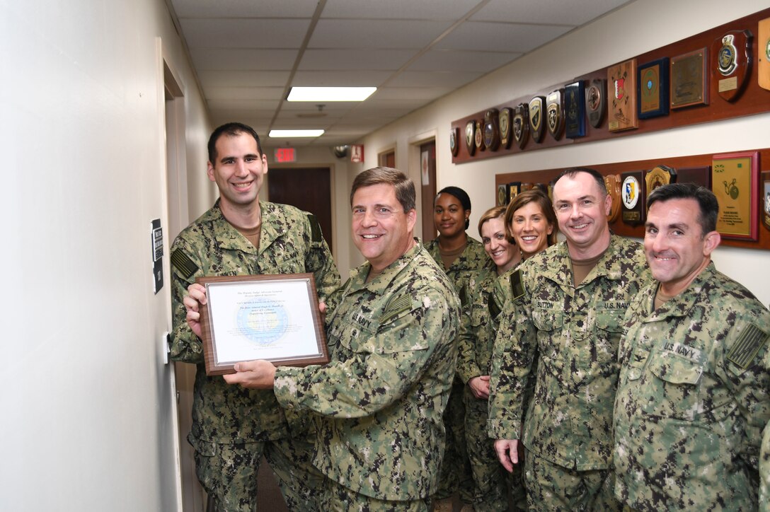 Lt. Cmdr. Allen Linken, a native of Bessemer, Ala., and assigned to Navy Reserve U.S. 5th Fleet (NR C5F) Legal, accepts the 2017 Rear Adm. Hugh H. Howell, Jr. Award of Excellence from Rear Adm. Thomas Marotta, U.S. Naval Forces Central Command (NAVCENT) vice commander, at NAVCENT Headquarters in Manama, Bahrain. NR C5F Legal is recognized for their ingenuity and flexibility in resolving gapped-manning issues and providing U.S. stateside collaborations for operational and international law. (U.S. Navy photo by Mass Communication Specialist 2nd Class Kevin J. Steinberg)