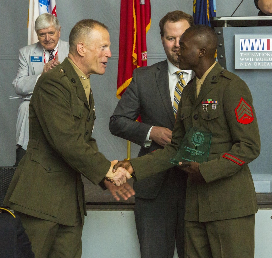Maj. Gen. Burke Whitman (left), commanding general of 4th Marine Division, Marine Forces Division, congratulates Sgt. Juvante Butler (right), an administrative specialist with 4th Marine Division, Marine Forces Reserve, at the World War II Museum in New Orleans, May 20, 2017. Butler was awarded the Mayor’s Community Service Award for his mentorship with the Knights of Pythagoras as a counselor for young men in the New Orleans community. (U.S. Marine Corps photo by Pfc. Melany Vasquez / Released) 
