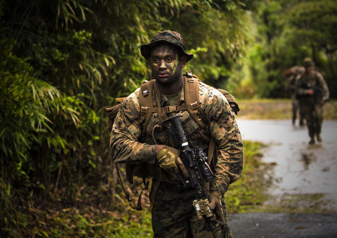 Lance Cpl. Stedji Legros conducts a patrol at Jungle Warfare Training Center, Camp Gonsalves, Okinawa, Japan, May 17, 2017. The unit patrolled through the woods, conducted medical evacuations and assaulted enemy villages during their 12-day training iteration. The training prepares them for their upcoming deployment to Thailand and the Philippines in support of the Cooperation Afloat Readiness and Training multilateral exercise. Legros, a Newark, New Jersey native, is a rifleman with Company K, 3rd Battalion, 8th Marine Regiment and is assigned to 3rd Marine Division, III Marine Expeditionary Force, through the unit deployment program. (U.S. Marine Corps photo by Lance Cpl. Joshua Pinkney)
