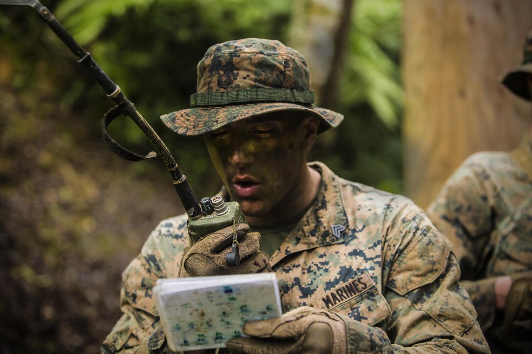 Sgt. Jakob Castaneda calls for a medical evacuation, May 17, 2017, at Jungle Warfare Training Center, Camp Gonsalves, Okinawa, Japan. The unit patrolled through the woods, conducted medical evacuations and assaulted enemy villages during their 12-day training iteration. The training prepared them for their upcoming deployment to Thailand and the Philippines in support of the Cooperation Afloat Readiness and Trainingmultilateral exercise. Castaneda, a native of Fresno, California, is a squad leader for Company K, 3rd Battalion, 8th Marine Regiment and is assigned to 3rd Marine Division, III Marine Expeditionary Force, through the unit deployment program. (U.S. Marine Corps photo by Lance Cpl. Joshua Pinkney)