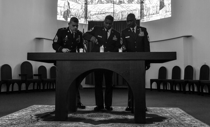 Representatives from the U.S Army Garrison Rheinland-Pfalz, U.S. Air Forces in Europe Air Forces Africa, and Ramstein Area Chief’s Group light candles during the RACG and German-American and International Women's Club's Kindergraves Memorial Service at U.S. Army Daenner Kaserne, Germany, May 20, 2017. The Kindergraves are the final resting place for 452 American children who died at or shortly after birth from 1952 to 1971. The memorial ceremony also included an invocation, wreath lying, and a blessing of the graves. (U.S. Air Force photo by Senior Airman Tryphena Mayhugh)