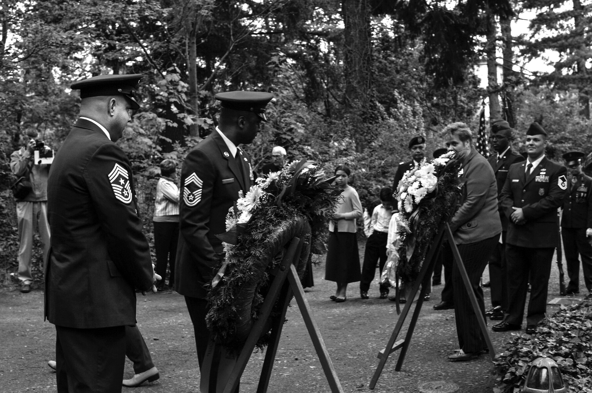 U.S. Air Force Chief Master Sgt. Aaron Bennett (left), 86th Airlift Wing command chief, and U.S. Air Force Chief Master Sgt. Phillip Leonard, Ramstein Area Chief’s Group lead, lay a wreath during the RACG and German-American and International Women's Club's Kindergraves Memorial Service in Kaiserslautern, Germany, May 20, 2017. The Kindergraves are the final resting place for 452 American children who died at or shortly after birth from 1952 to 1971. The memorial ceremony also included an invocation, candle lighting, and a blessing of the graves. (U.S. Air Force photo by Senior Airman Tryphena Mayhugh)