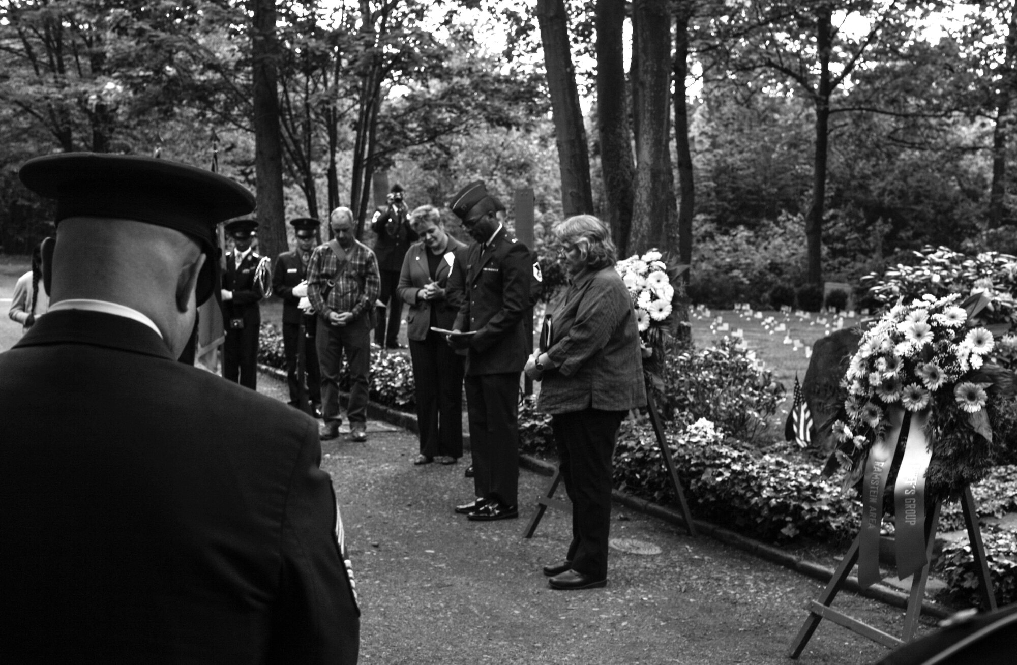 U.S. Air Force Capt. Marcus Branch, 86th Airlift Wing chaplain, blesses the graves of 452 American children during the Ramstein Area Chief's Group and German-American and International Women's Club's Kindergraves Memorial Service in Kaiserslautern, Germany, May 20, 2017. The Kindergraves are the final resting place for 452 American children who died at or shortly after birth from 1952 to 1971. Every year after Mother’s Day, members of the Kaiserslautern Military Community honor their memory with a memorial service. (U.S. Air Force photo by Senior Airman Tryphena Mayhugh)