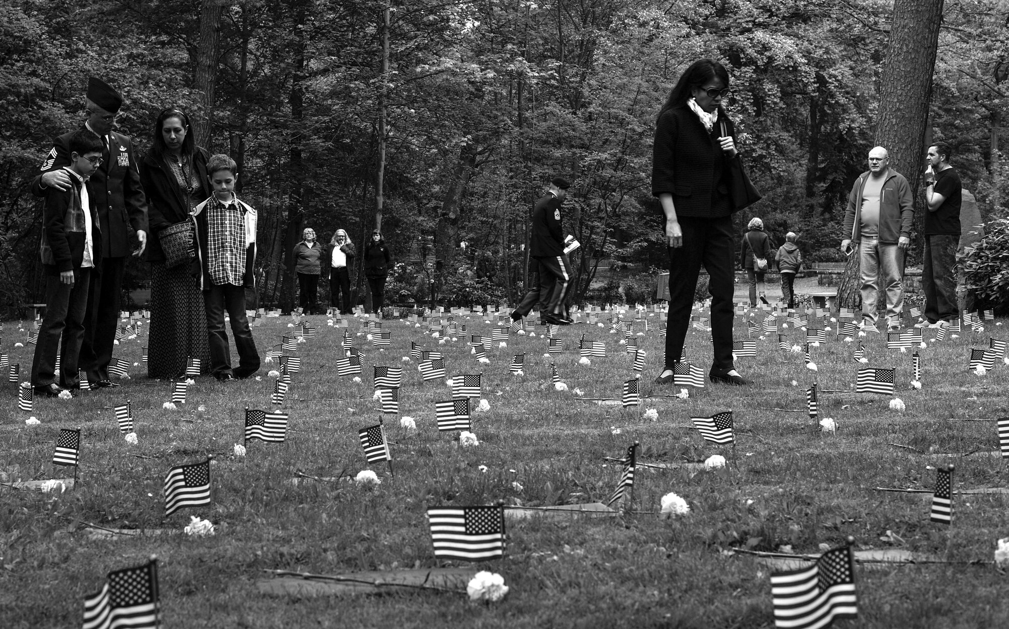 Members of the Kaiserslautern Military Community pay their respects to American children buried at the Kaiserslautern Kindergraves during the Ramstein Area Chief's Group and German-American and International Women's Club's Kindergraves Memorial Service in Kaiserslautern, Germany, May 20, 2017. The Kindergraves are the final resting place for 452 American children who died at or shortly after birth from 1952 to 1971. The memorial ceremony included an invocation, laying wreaths, candle lighting, and a blessing of the graves. (U.S. Air Force photo by Senior Airman Tryphena Mayhugh)
