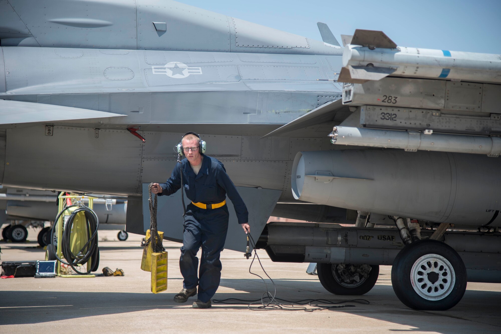 U.S. Air Force Airman 1st Class Evan Wilcox, a 35th Maintenance Group dedicated crew chief, removes chalks from a F-16 Fighting Falcon's tires at Kunsan Air Base, Republic of Korea, May 19, 2017. Wilcox is responsible for ensuring every component of the F-16 Fighting Falcon is maintained to the highest standards, making sure it is ready to fly at a moment’s notice so that pilots can safely and effectively complete their mission. (U.S. Air Force photo by Senior Airman Brittany A. Chase)
