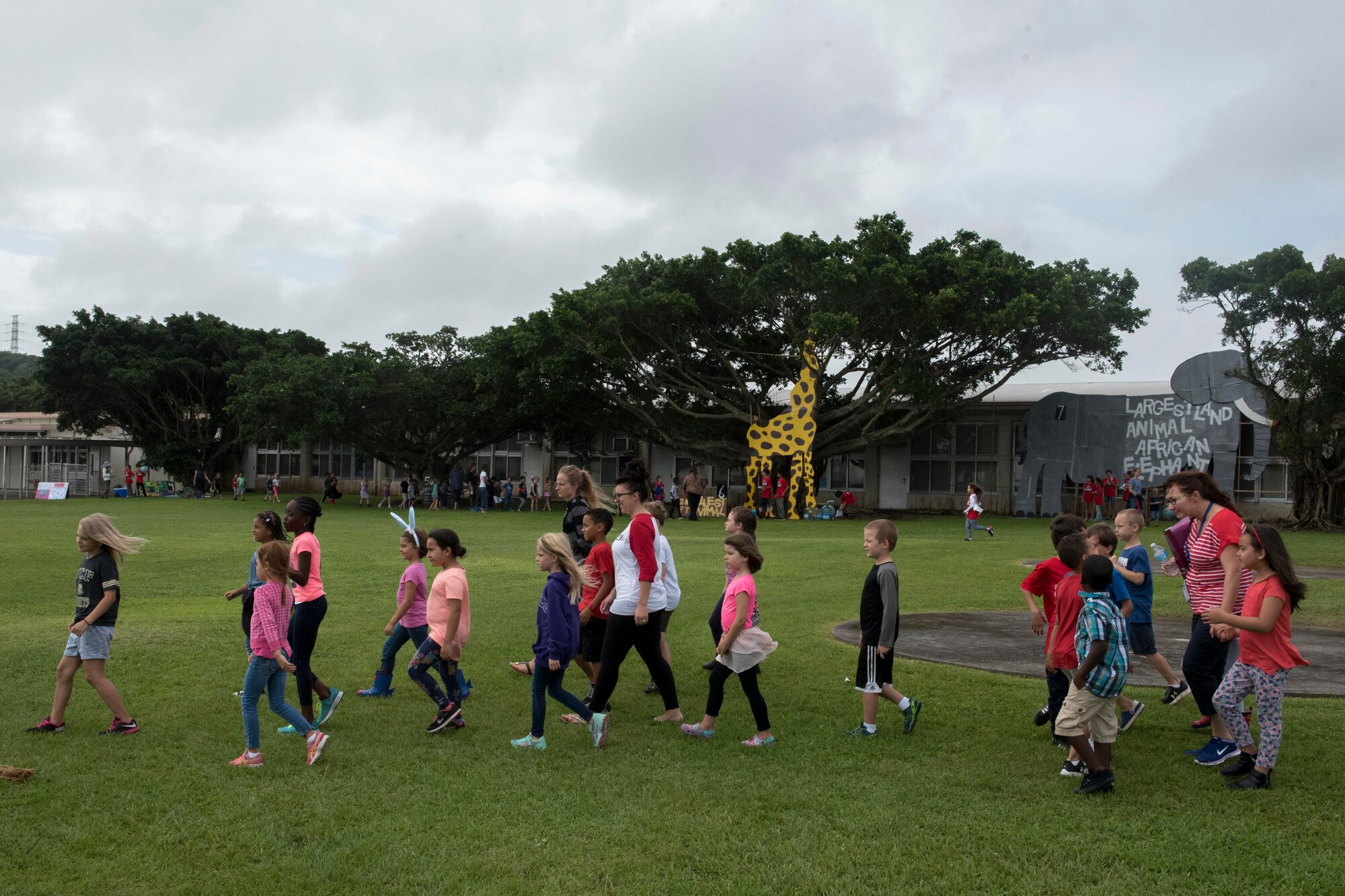 Children from Kadena Elementary School walk from one educational booth to another May 22, 2017, at Kadena Air Base, Japan. The school’s English as a Second Language team presented 12 stations representing the Guinness Book of World Records to the whole school. (U.S. Air Force photo by Senior Airman John Linzmeier)