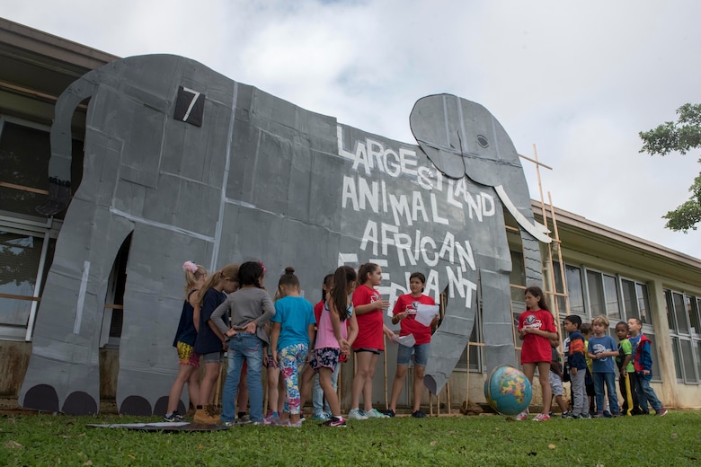 Children from Kadena Elementary School gather around a cardboard cutout of the world’s largest land-walking animal, an African elephant, May 22, 2017, at Kadena Air Base, Japan. The event produced by members of the school’s English as a Second Language team and was held to teach cross-curricular subjects such as science, health, history and geography. (U.S. Air Force photo by Senior Airman John Linzmeier)