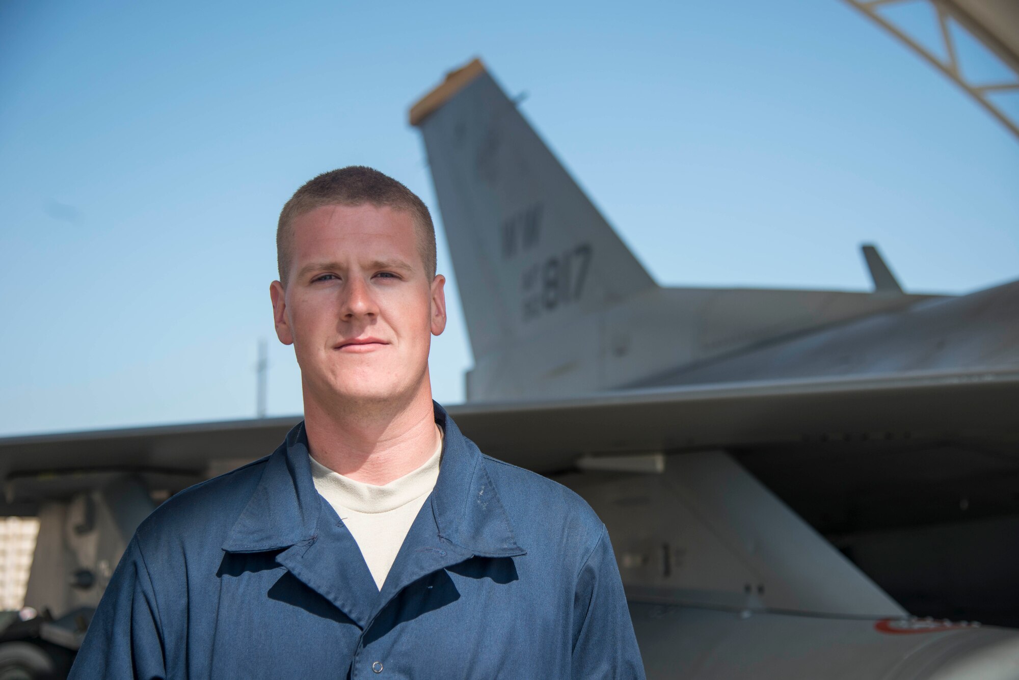 U.S. Air Force Airman 1st Class Drew Norton, a 35th Aircraft Maintenance Squadron dedicated crew chief, poses for a photo at Kunsan Air Base, Republic of Korea, May 19, 2017. Norton is responsible for ensuring every component of the F-16 Fighting Falcon is maintained to the highest standards, making sure it is ready to fly at a moment’s notice so that pilots can safely and effectively complete the mission. (U.S. Air Force photo by Senior Airman Brittany A. Chase)