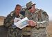 Maj. Chris Larson, Train, Advise, Assist Command-Air (TAAC-Air) air-to-ground integration lead advisors, coordinates information with his Afghan Air Force counterpart before a live-fire training exercise for a class of Afghan Tactical Air Coordinators near Logar Province, Afghanistan, May 21, 2017. Prior to the exercise, advisors from TAAC-Air conducted three weeks of classroom training. The live fire exercise is part of a practical evaluation before Afghan Air Force personnel can graduate as ATACs. (U.S. Air Force photos by Tech. Sgt. Veronica Pierce)
