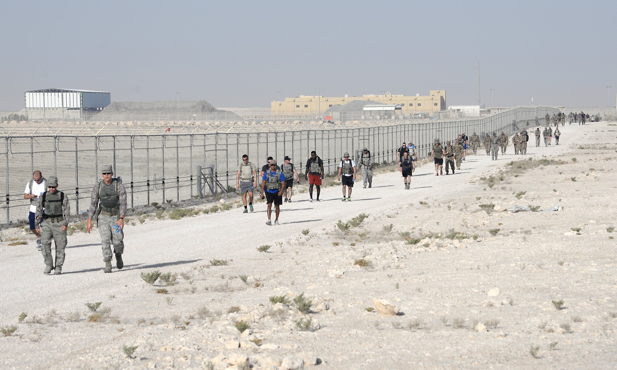 Members of the 379th Expeditionary Security Forces Squadron take part in an early morning ruck march on day two of police week at Al Udeid Air Base, Qatar May 16, 2017. Airmen from the 379th ESFS organized a week of law enforcement activities to honor fallen civilian police officers, security forces airmen and U.S. Air Force Office of Special Investigations agents who died in the line of duty. (U.S. Air Force photo by Tech. Sgt. Bradly A. Schneider)