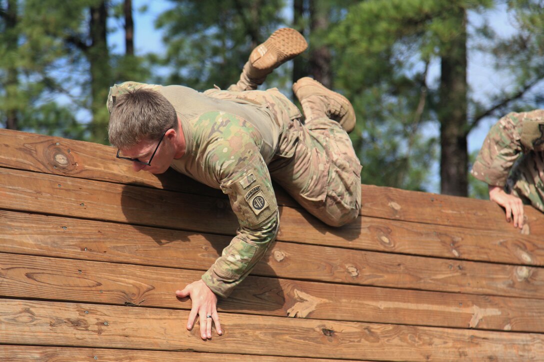 A paratrooper jumps over the high wall obstacle as part of the Best Squad Competition during All American Week at Fort Bragg, N.C., May 22, 2017. Army photo by Staff Sgt. Amber Stephens