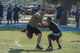 An Airman from the 822d Base Defense Squadron breaks a tackle from a 23d Security Forces Squadron member during Police Week’s football tournament, May 18, 2017, at Moody Air Force Base, Ga. Police Week is designed to honor the legacies fallen officers, both civilian and military, have left behind, but it also gives various sections within the law enforcement community an opportunity to train together in friendly competitions. (U.S. Air Force photo by Senior Airman Greg Nash) 