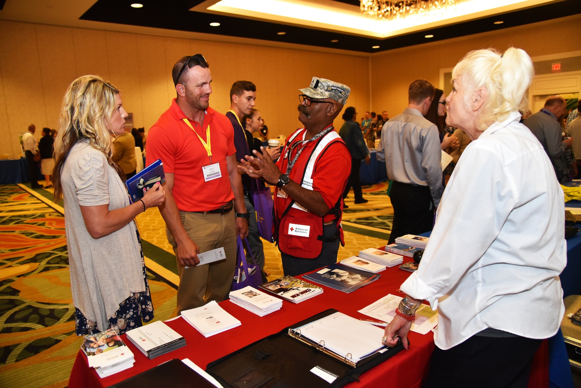 R.P. Warner, Services for the Armed Forces and Disaster Preparedness team member, and Sgt. 1st Class (Ret.) Pedro Quinonez, Services for the Armed Forces Central Florida and Space Coast lead, talk to attendees at the Yellow Ribbon Reintegration Program event on May 20 in Orlando, Florida. The American Red Cross provides a myriad of benefits to Reserve Citizen Airmen and their loved ones during a deployment when there's an emergency or disaster. (U.S. Air Force photo by Staff Sgt. Adam C. Borgman)