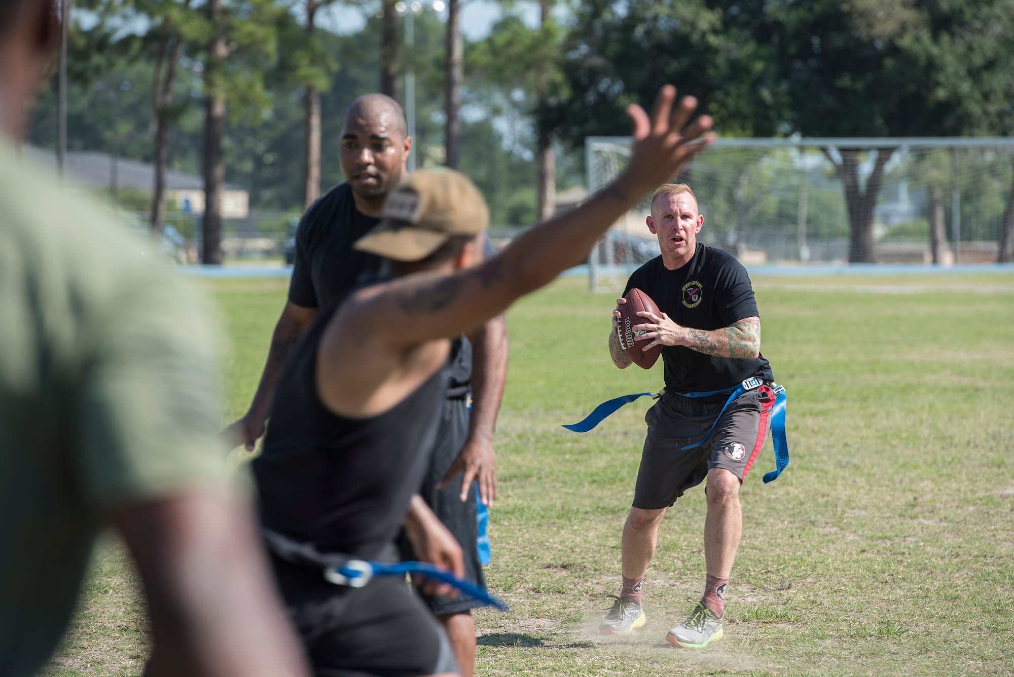 A competitor from the 23d Security Forces Squadron scans the field before attempting a pass during Police Week’s football tournament, May 18, 2017, at Moody Air Force Base, Ga. Police Week is designed to honor the legacies fallen officers, both civilian and military, have left behind, but it also gives various sections within the law enforcement community an opportunity to train together in friendly competitions. (U.S. Air Force photo by Senior Airman Greg Nash)