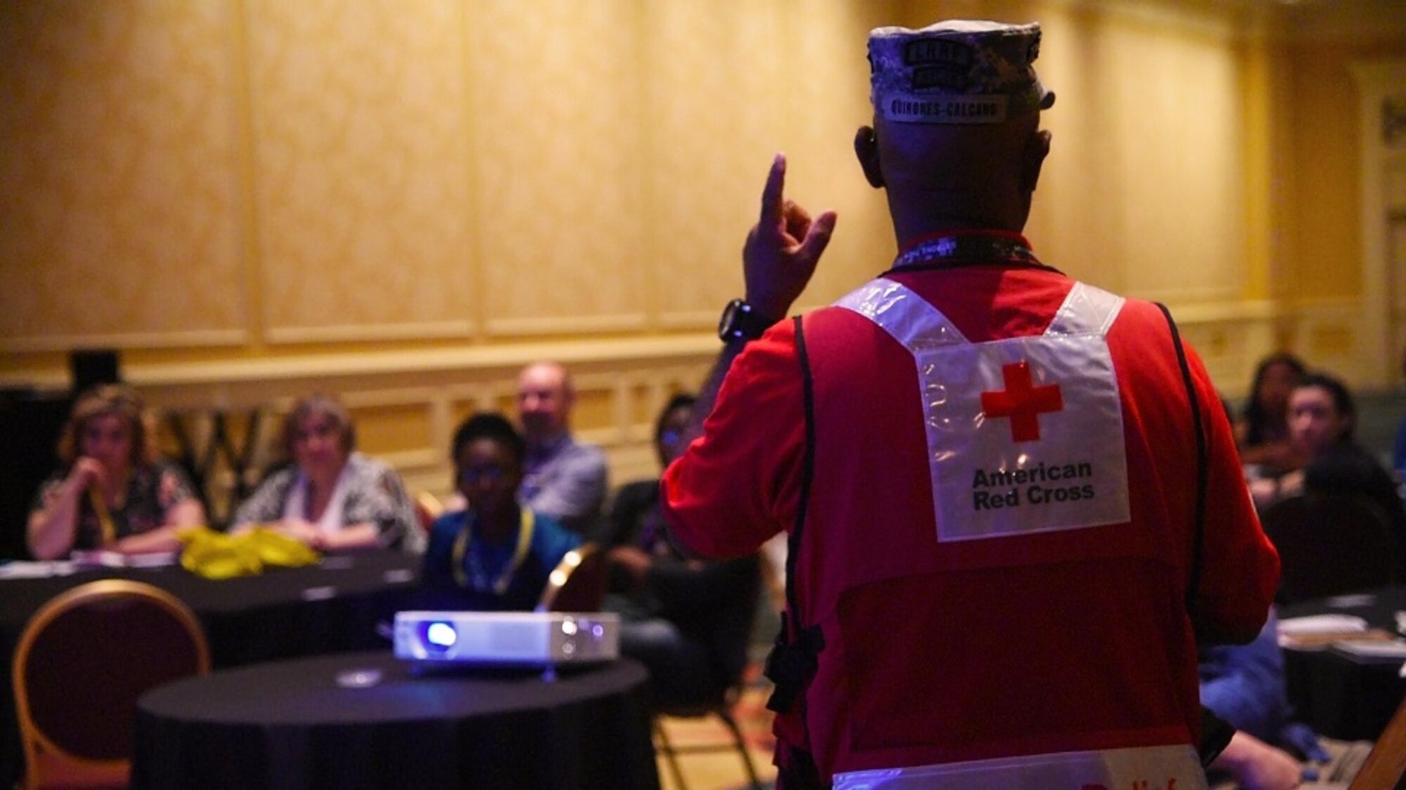 Sgt. 1st Class (Ret.) Pedro Quinonez speaks to approximately 25 members about the benefits the American Red Cross can provide to Reserve Citizen Airmen and their loved ones during a Yellow Ribbon Reintegration program event in Orlando, Florida on May 20. The most significant benefit they can provide when the member is deployed is a complimentary extraction if there's an emergency within their immediate family. (U.S. Air Force photo by Staff Sgt. Adam C. Borgman)