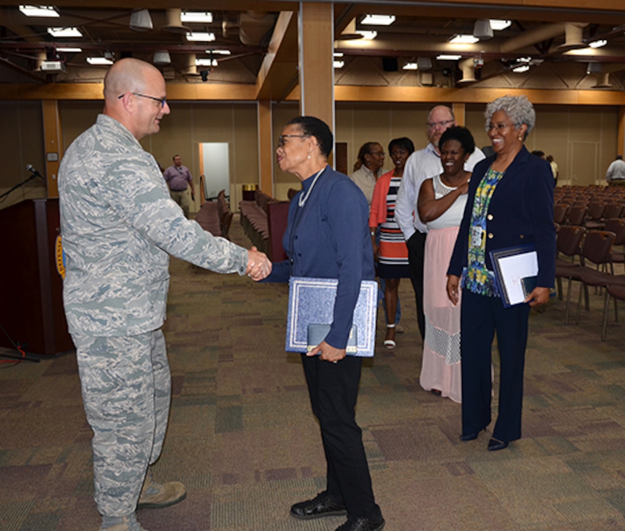 Defense Logistics Agency Aviation Support Team deployee Valerie Ashe shakes DLA Aviation Commander Air Force Brig. Gen. Allan Day’s hand at the conclusion of his last Town Hall May 17, 2017 in the Frank B. Lotts Conference Center on Defense Supply Center Richmond, Virginia. 
