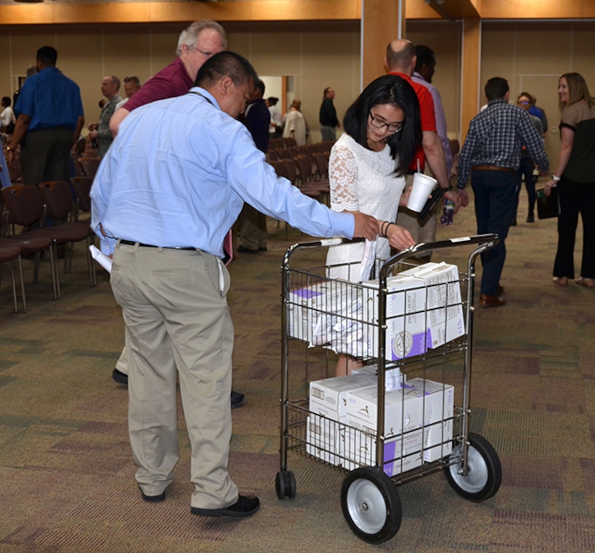 Employees enjoy an ice cream treat at the conclusion of DLA Aviation Commander Air Force Brig. Gen. Allan Day’s last Town Hall May 17, 2017 in the Frank B. Lotts Conference Center on Defense Supply Center Richmond, Virginia. (Photo by Jackie Roberts)