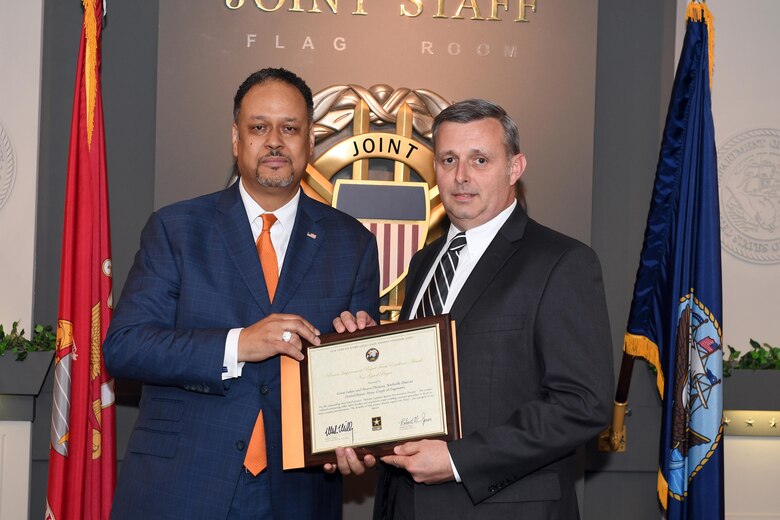 Dr. Charles Brandon (Left), director of the Office of Business Transformation, presents an individual certificate to Tim Dunn, U.S. Army Corps of Engineers Nashville District deputy chief of Operations, for his part as a team member that earned the Army’s Lean Six Sigma Award Program Process Improvement Project Team Excellence Award.  Brandon made the presentation during the 2016 Lean Six Sigma excellence awards program ceremony May 18, 2017 at the Pentagon in Arlington, Va. 