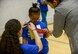 U.S. Army Sgt. Brenda Contreras, 5th Quartermaster, 21st Special Troops Battalion, 21st Theater Sustainment Command, pins a ribbon on Aviella, a special Olympian, on Ramstein Air Base, Germany, May 19, 2017. Aviella and the other students competing in the 2017 Spring Kaiserslautern Military Community Special Olympics received a volunteer to accompany them as a “buddy” throughout the day. (U.S. Air Force photo by Staff Sgt. Timothy Moore)