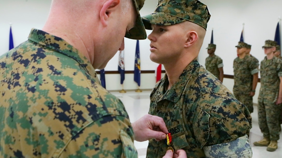 Lt. Col. Vincent Dawson (left), the executive officer of Marine Aircraft Group 41, Marine Forces Reserve, awards Cpl. David Qualls, a motor transport assistant operations chief with Marine Wing Support Squadron 471, 4th Marine Aircraft Wing, MARFORRES, the Navy and Marine Corps medal at the 1st Battalion, 23rd Marine Regiment headquarters in Houston, Texas, May 20, 2017. In 2014, Qualls helped save a man stuck in a burning vehicle. According to Qualls’ award summary, had he not arrived when he did, the man would have surely died. (U.S. Marine Corps photo by Cpl. Dallas Johnson)