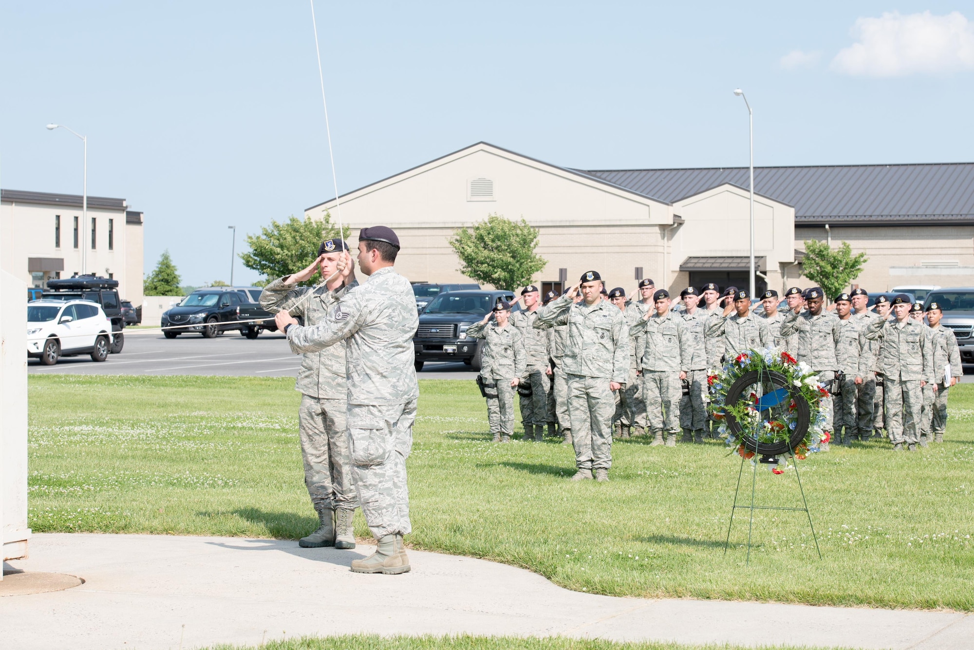 A 436th Security Forces Squadron flag detail lowers the U.S. Flag during a retreat ceremony May 19, 2016 at Dover Air Force Base, Del. The ceremony marked the end of National Police Week. (U.S. Air Force photo by Mauricio Campino)