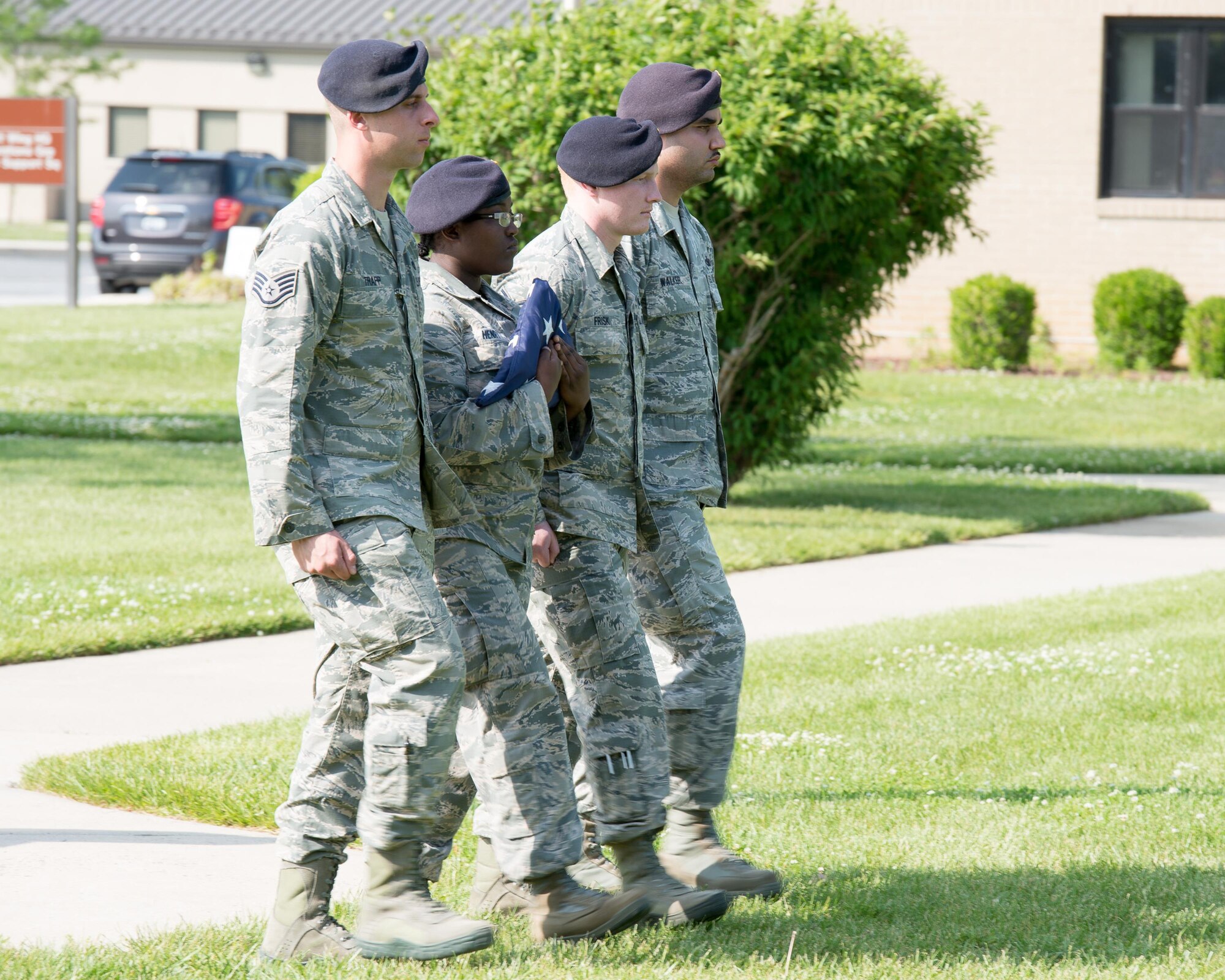 A 436th Security Forces Squadron flag detail march with a folded U.S. Flag at the end of a retreat ceremony May 19, 2016 at Dover Air Force Base, Del. The ceremony included a guest speaker, a poem recital and a commemoration of U.S. Air Force Security Forces personnel killed in combat. (U.S. Air Force photo by Mauricio Campino)