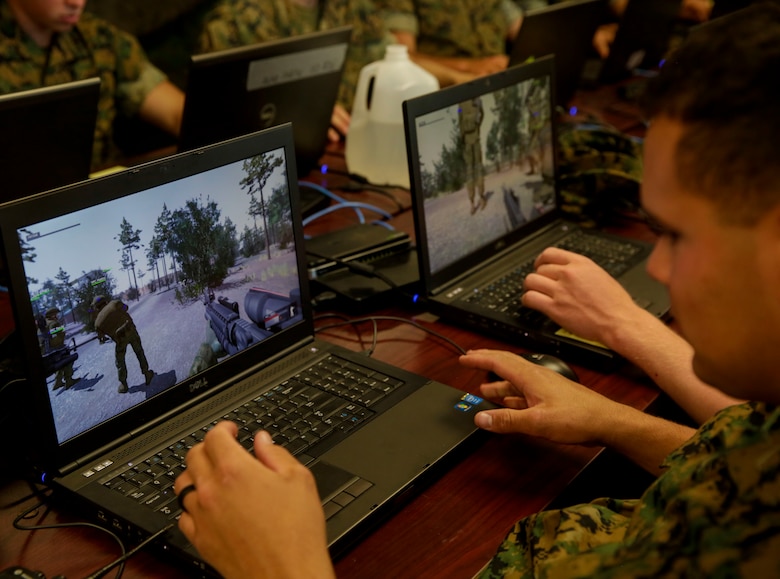 A Marine familiarizes himself with the controls of a virtual training program during a Spartan Tactical Games competition at Camp Lejeune, N.C., May 16, 2017. The Marines participated in a squad versus squad virtual training exercise to improve their tactics and maneuvers in a controlled environment. The Marines are with 2nd Battalion, 6th Marine Regiment. (U.S. Marine Photo by Lance Cpl Leynard Kyle Plazo)
