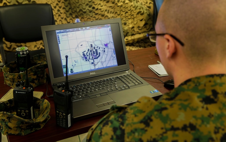 A Marine looks at a computer displaying the positions of both teams during a Spartan Tactical Games competition at Camp Lejeune, N.C., May 16, 2017. The Marines participated in a squad versus squad virtual training exercise to improve their tactics and maneuvers in a controlled environment. The Marines are with 2nd Battalion, 6th Marine Regiment. (U.S. Marine Photo by Lance Cpl. Leynard Kyle Plazo)