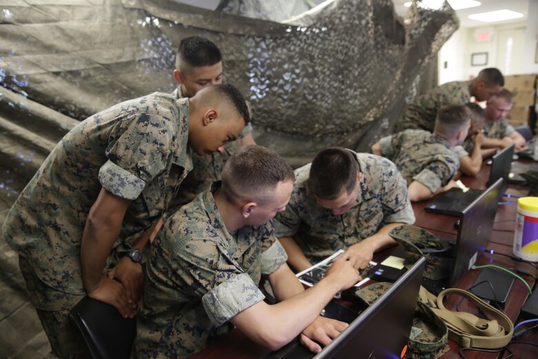 Marines discuss during a Spartan Tactical Games competition at Camp Lejeune, N.C., May 17, 2017. The Marines participated in a squad versus squad virtual training exercise to improve their tactics and maneuvers in a controlled environment. The Marines are with 2nd Battalion, 6th Marines Regiment. (U.S. Marine Photo by Lance Cpl Leynard Kyle Plazo)