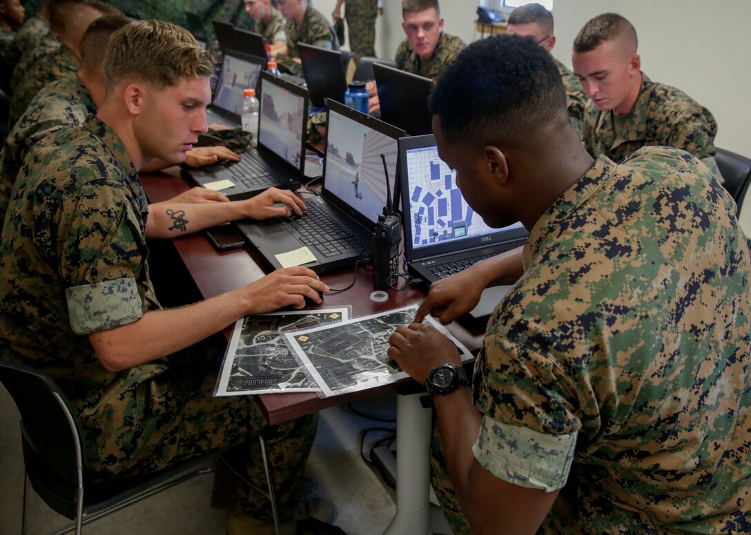 Marines discuss enemy positions during a Spartan Tactical Games competition at Camp Lejeune, N.C., May 17, 2017. The Marines participated in a squad versus squad virtual training exercise to improve their tactics and maneuvers in a controlled environment. The Marines are with 2nd Battalion, 6th Marine Regiment.  (U.S. Marine Photo by Lance Cpl Leynard Kyle Plazo)