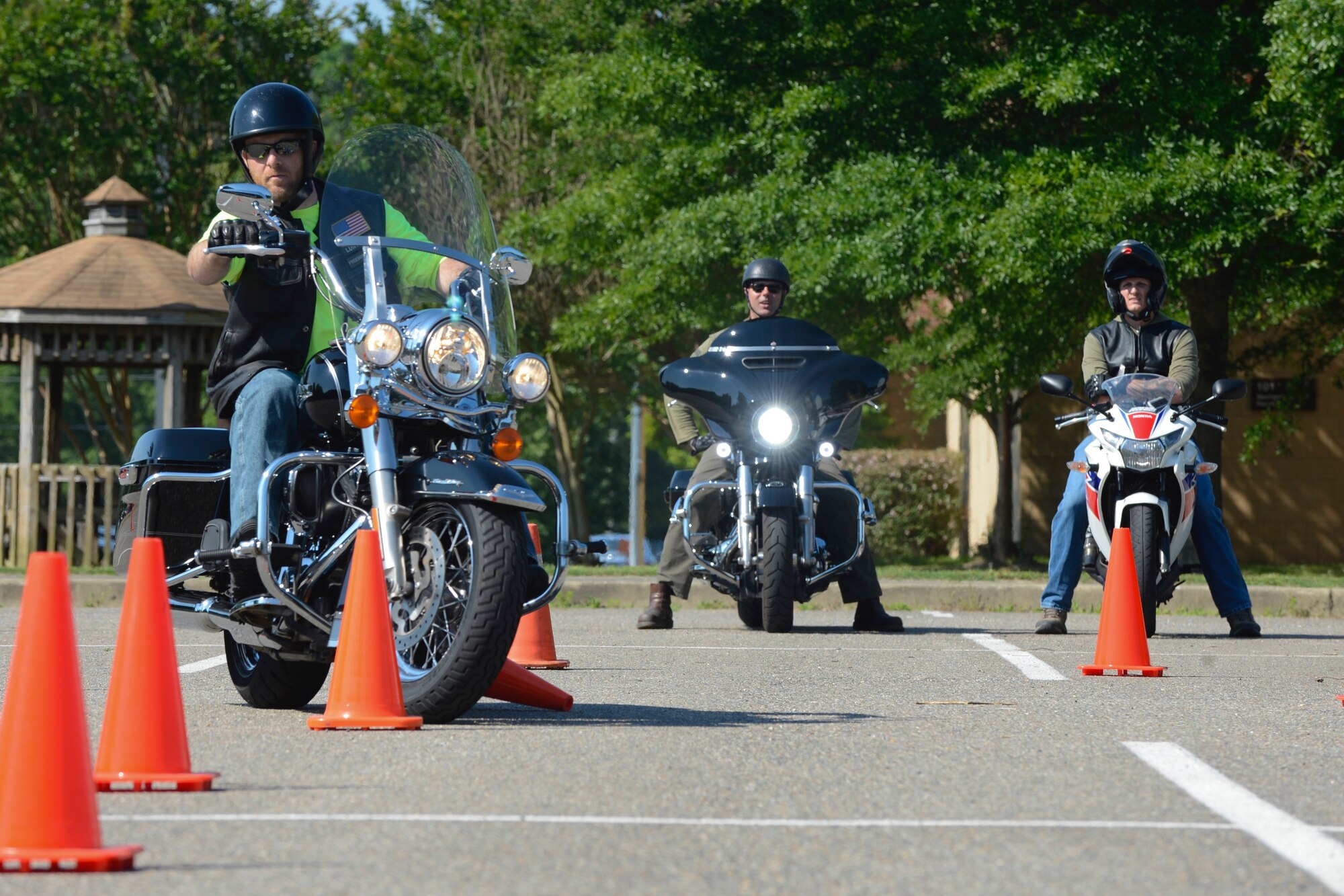U.S. Army Master Sgt. Benjamin Park, Green Knights Military Motorcycle Club member, weaves through traffic cones during the Armed Forces Motorcycle Safety event and ride at Joint Base Langley-Eustis, Va., May 19, 2017. The Green Knights performed safety checks on all the bikes that checked in for the event. (U.S. Air Force photo/Airman 1st Class Kaylee Dubois)