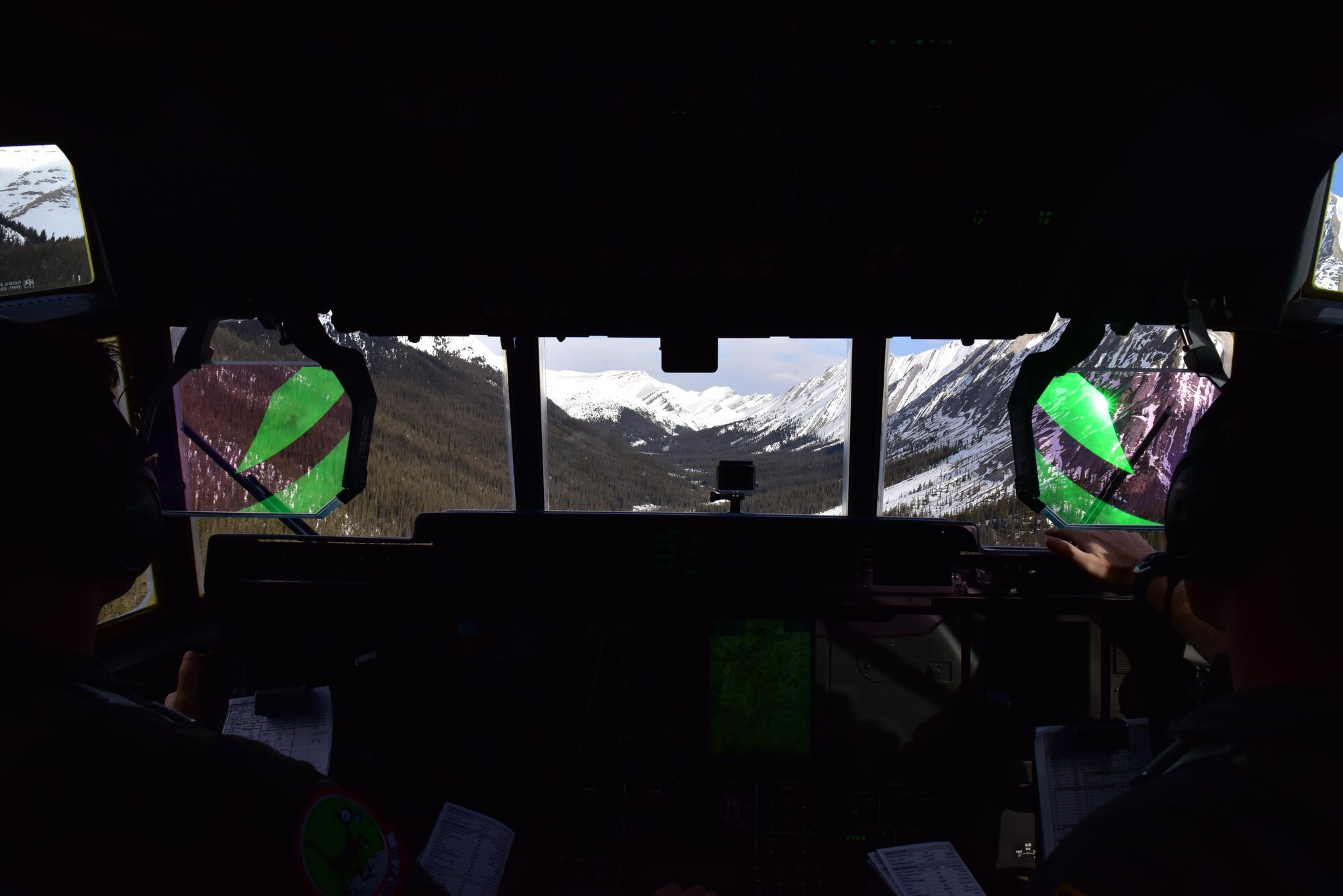 U.S. Air Force Capt. David Tart , left, and 1st Lt. Alex Randall, 41st Airlift Squadron pilots, fly in formation with a Canadian C-130J in the Canadian Rockies executing low altitude high terrain evasion maneuvers during the first Fanatic Pegasus exercise mission with Royal Canadian air forces in Alberta, Canada, April 20, 2017. This is the first time American forces have participated in this exercise which establishes air and ground forces in unfamiliar terrain to work on communication and rapid deployment of those resources.
(U.S. Air Force photo by Staff Sgt. Jeremy McGuffin)