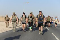 Members of the 379th Expeditionary Security Forces Squadron take part in an early morning ruck march on day two of police week at Al Udeid Air Base, Qatar, May 16, 2017. Airmen from the 379th ESFS organized a week of law enforcement activities to honor fallen civilian police officers, security forces airmen and U.S. Air Force Office of Special Investigations agents who died in the line of duty. (U.S. Air Force photo by Tech. Sgt. Bradly A. Schneider)