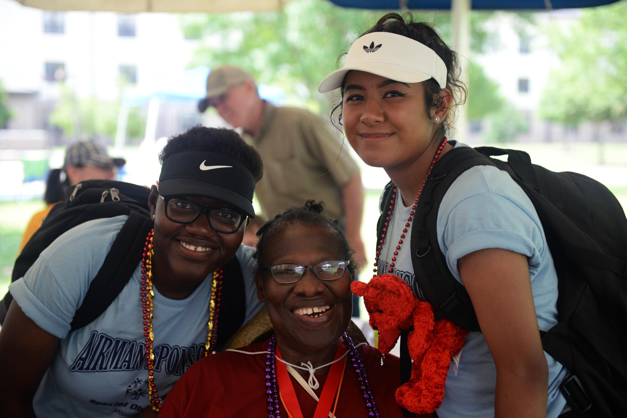 Renalda Lamour and Margarita Anguiano, 335th Training Squadron Airman sponsors, and Queen Greenlaw, Area 6 athlete, pose for a photo during the Special Olympics Mississippi 2017 Summer Games at Olympic Village May 20, 2017, on Keesler Air Force Base, Miss. Keesler hosted more than 3,200 athletes, directors, coaches, family members and volunteers spanning over 16 regions across Mississippi for the 31st year. (U.S. Air Force photo by Airman 1st Class Travis Beihl)