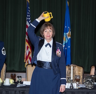 Colonel Michelle Hayworth, 688th Cyberspace Wing commander, participates in the tradition of "Skulling In" during a Dining Out celebrating the 92nd Cyberspace Operations Squadron's 75th anniversary May 12, 2017, at Joint Base San Antonio-Lackland. The tradition derives from the 92nd COS motto, "Once A Skull, Always A Skull".
