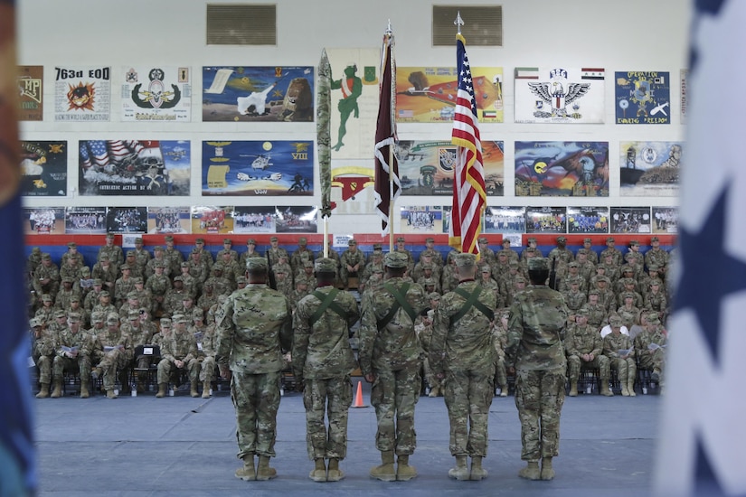 Soldiers hold the colors as they wait for the transfer of authority ceremony to begin between the 31st Combat Support Hospital and 86th Combat Support Hospital, in the Zone 1 Fitness Center, Camp Arifjan, Kuwait, May 5. The 86th CSH will assume authority of the United States Military Hospital-Kuwait with Col. Bruce Syvinski and Command Sgt. Maj. Daryl Forsythe as the command team. (U.S. Army photo by Sgt. Bethany Huff, ARCENT Public Affairs)