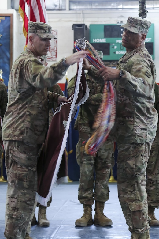 Col. George Kyle (right), the commander of the 31st Combat Support Hospital, and Command Sgt. Maj. Robert Nelson, the command sergeant major for the 31st CSH, cases the unit’s colors, during a transfer of authority ceremony, in the Zone 1 Fitness Center, Camp Arifjan, May 5. The ceremony transferred the authority of the United States Military Hospital- Kuwait from the 31st CSH to the 86th CSH. (U.S. Army photo by Sgt. Bethany Huff, ARCENT Public Affairs)