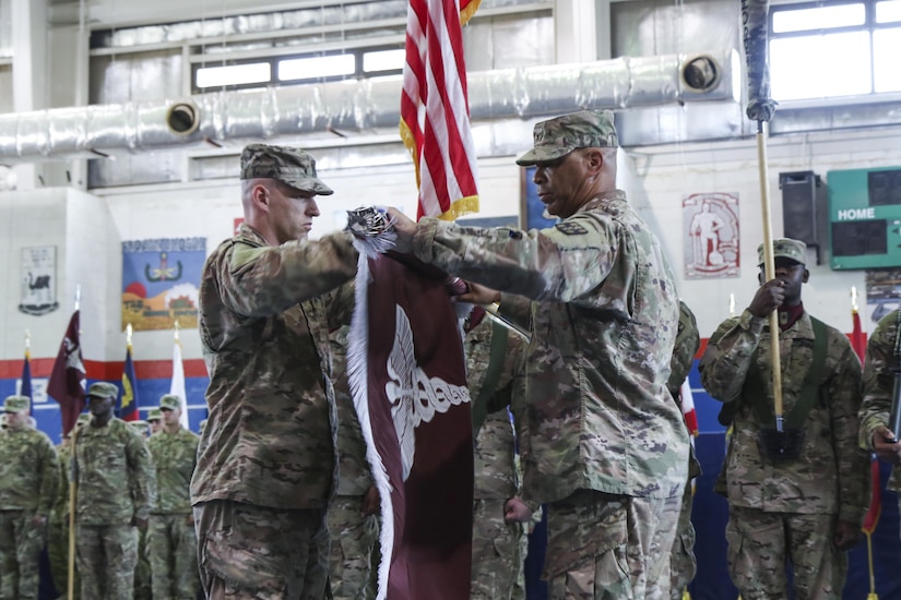 Col. George Kyle (right), the commander of the 31st Combat Support Hospital, and Command Sgt. Maj. Robert Nelson, the command sergeant major for the 31st CSH, cases the unit’s colors, during the transfer of authority ceremony, in the Zone 1 Fitness Center, Camp Arifjan, Kuwait, May 5. The ceremony marked the last deployment for the 31st CSH, as it will transform into a field hospital unit upon returning to the United States. (U.S. Army photo by Sgt. Bethany Huff, ARCENT Public Affairs)